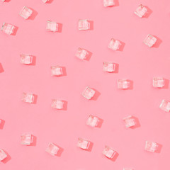 Wall Mural - Ice cubes pattern on pastel pink background. Minimal summer drink concept. Flat lay.