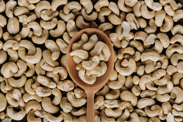 Top view of tasty cashew and one wooden spoon