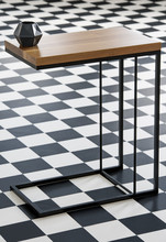 Real Photo With Close-up Of Wood And Metal End Table With Black Geometric Small Vase Standing On Checkerboard Floor