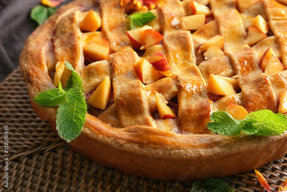Tasty homemade peach pie on table, closeup