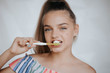 © ZoomStudio - Woman smile. Teeth whitening. Dental care. Happy young woman brushing teeth.