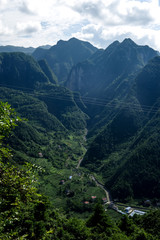 View of a stretch of Mountains with Green Trees