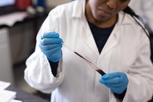 Midsection Of Scientist Analyzing Blood Samples In Laboratory