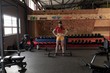 © Wavebreak Media - Woman preparing to lift barbell in gym