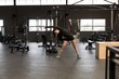 © Wavebreak Media - Woman doing stretching exercise in fitness studio