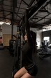 © Wavebreak Media - Woman doing pull ups in fitness gym
