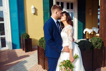 Beautiful Bride and Groom enjoy each other. happy romantic young couple celebrating their marriage. Sexy kissing stylish couple of lovers close up portrait. wedding concept.