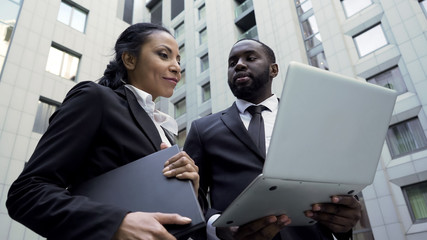 Business partners looking at investment project on laptop, new opportunities