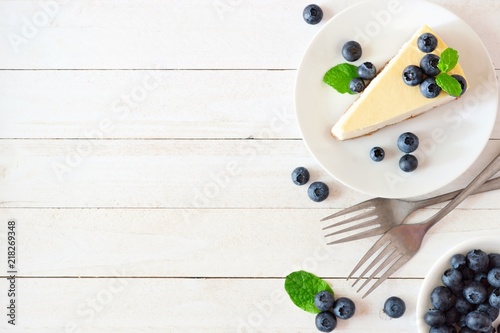 Fotografering  Slice of cheesecake with blueberries