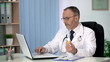 © motortion - Doctor making medicines order online for public procurement, working on laptop