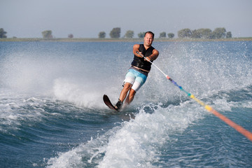 A slalom waterskier on a sunny morning.