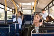 © Wavebreak Media - Woman listening music while travelling in modern bus