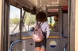 © Wavebreak Media - Female commuter taking ticket from driver in modern bus