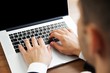 © BillionPhotos.com - Closeup of a Businessman Typing on a Laptop