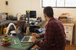 © Wavebreak Media - Mechanic using laptop on table in workshop