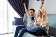 © Kencana Studio - asian malay couple watching tv together