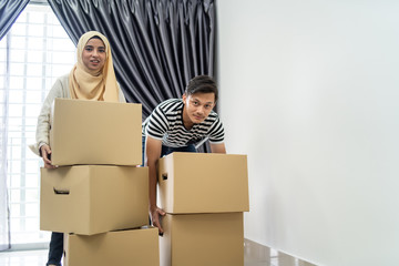 Wall Mural - asian couple moving house together with box