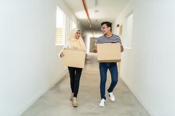 Wall Mural - asian couple moving house together with box