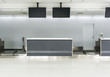 © Nischaporn - Empty desk in international airport at check-in counter with loading baggage area on background.