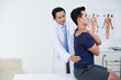 © DragonImages - Mature osteopath palpating low back of patient in his office