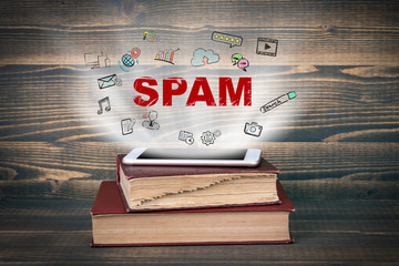 Wall Mural - Spam. Concept cloud coming from screen of the phone, books on the desk