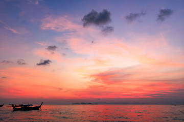 Wall Mural - sightseeing travel concept:traditional thai boats at sunset beach