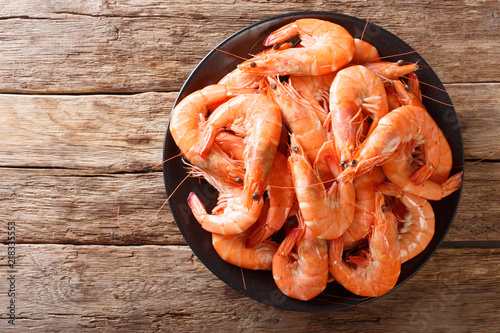 Cuadros en Lienzo Healthy diet food: boiled wild tiger shrimps close-up on a plate on a table