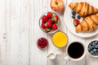 © ffphoto - Breakfast with croissants, coffee, jams and berries