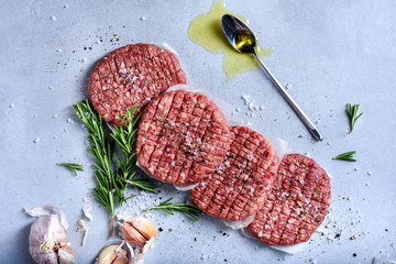 Raw burger cutlets, ground beef meat, hamburger ingredients.