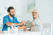 © LIGHTFIELD STUDIOS - male nurse measuring blood pressure to smiling senior woman