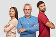 © WHstudio Leushin N - Together we can do everything. Photo of family: lovely woman, bearded adult male and grey haired mature man stand backs with crossed hands, have self confident expressions isolated on white background