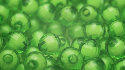 Poster - Green beads rotation background. Macro view.