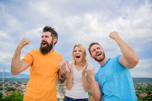 Fotografía Woman and men look emotional successful celebrate victory sky background