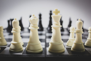 Closeup back view white chess on chess board.