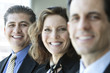 © Mint Images - A closeup portrait of a row of multi ethnic business people, with focus on the hispanic businessman.