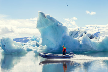 motor boat sailing on the azure waters between the icebergs