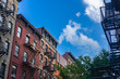 West Village pre-war apartment buildings with blue sky background.