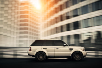 Wall Mural - Car drive on the road in a city at sunset