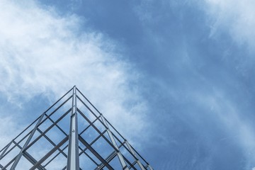 The construction of buildings with steel structure on sky background