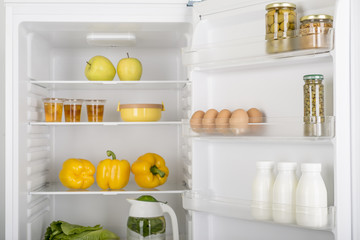 Open fridge full of fresh fruits and vegetables