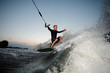 © fesenko - Active and young man riding on a wake board at the evening