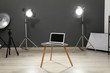 © New Africa - Interior of modern photo studio with laptop, table and professional equipment