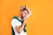 © New Africa - Young man with trendy hairstyle on color background