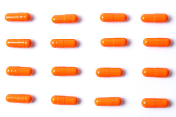 Orange pills with place for text on a white background. Medicine, health.