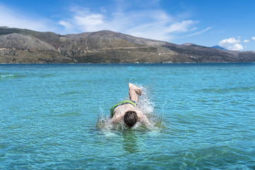 young man drops into the sea