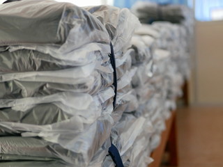 Stacks of clothes packed in plastic bags ready to be shipped / distributed