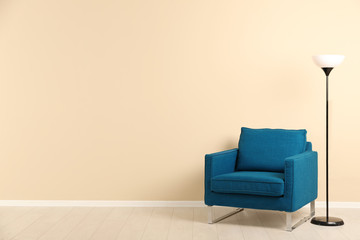 Poster - Stylish living room interior with comfortable armchair and space for text