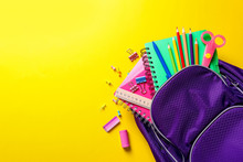 Flat Lay Composition With Backpack And School Stationery On Color Background