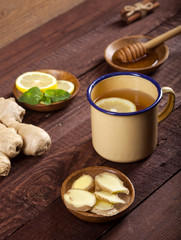 Wall Mural - Ginger tea with lemon, mint and honey on wooden background