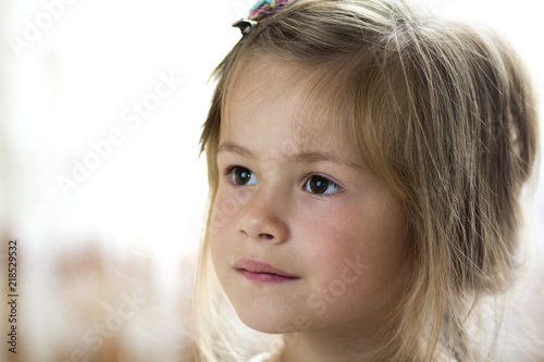 Portrait Of Little Pretty Young Child Girl With Gray Eyes And Clip In Scattered Fine Blond Hair Looking Dreamily In Distance On Blurred Sunny Background Beauty Dreams And Innocence Of Childhood clip in scattered fine blond hair